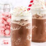chocolate frappuccinos in 2 glasses with red and whit straws