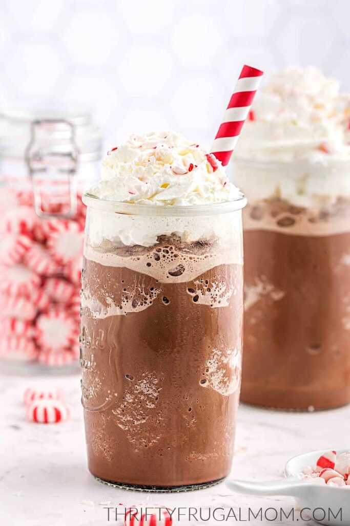 chocolate frappuccinos in 2 glasses with red and whit straws 