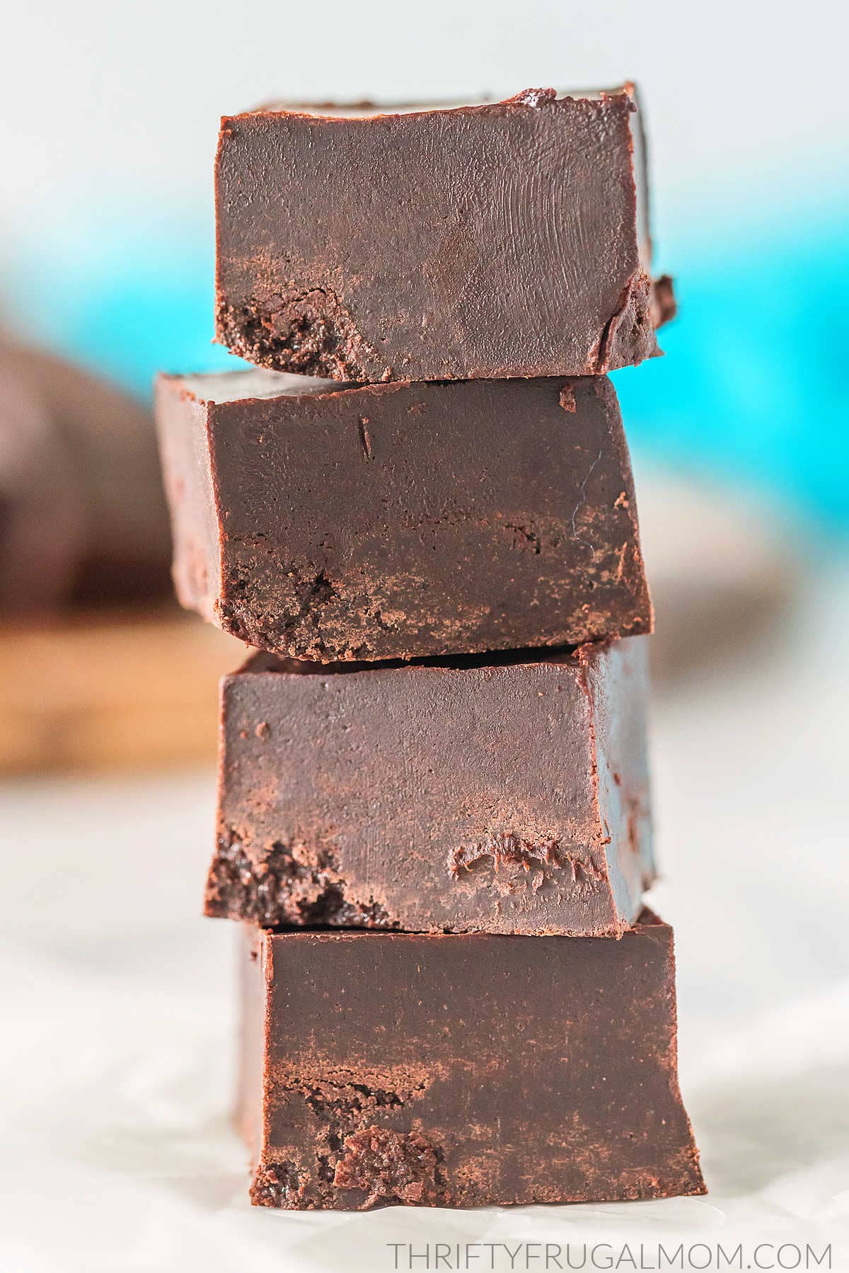 Four pieces of healthy 3 ingredient fudge stacked on top of each other