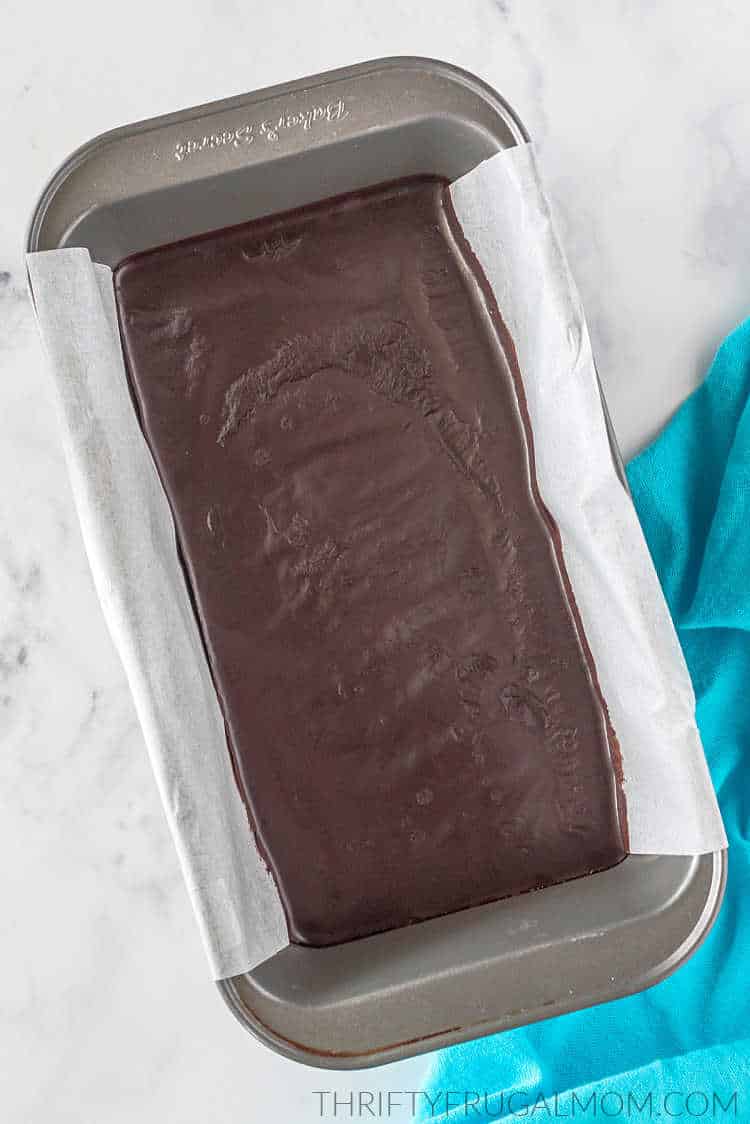 3 ingredient chocolate fudge in a parchment paper lined loaf pan