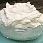 a glass bowl full of homemade whipped cream.