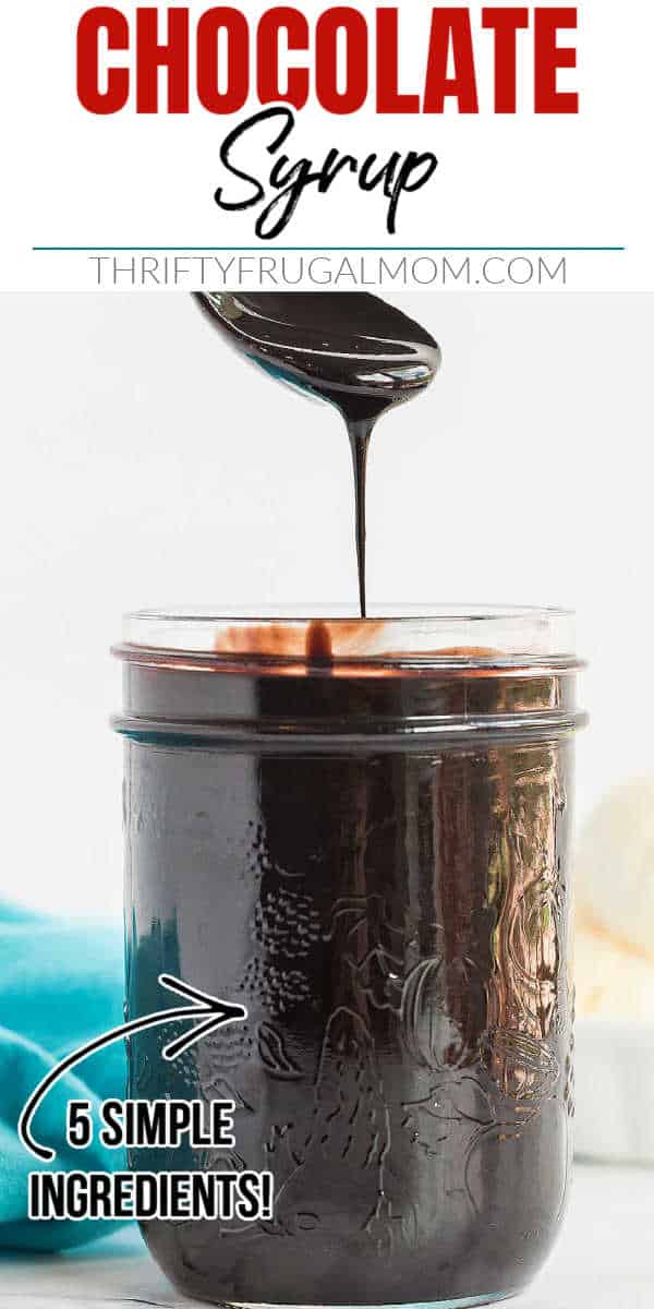 homemade chocolate syrup being spooned out of a small mason jar