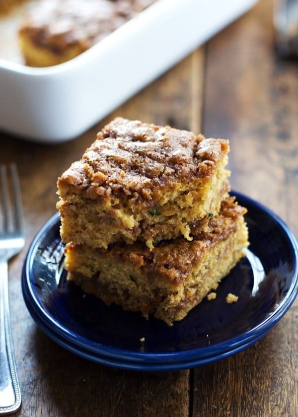 zucchini coffee cake slices stacked on blue plate
