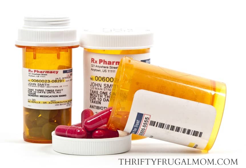 prescription medication bottles, one with pills spilling out