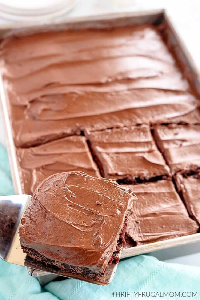 chocolate cake frosting with homemade icing cut into squares in a pan
