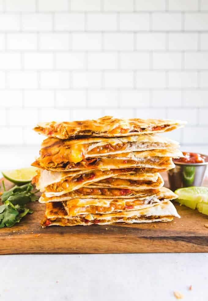 a stack of meatless lentil quesadillas on a wooden table