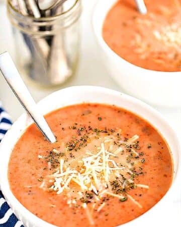 a white bowlful of homemade creamy tomato basil soup