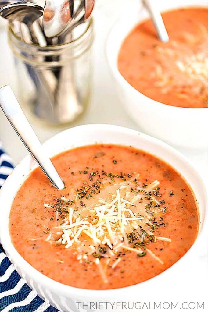 a white bowlful of homemade creamy tomato basil soup