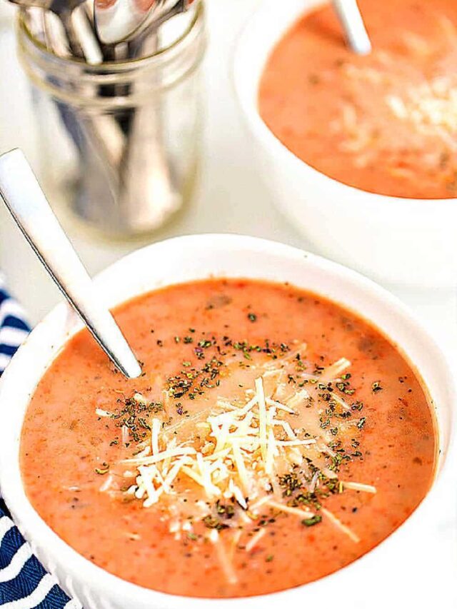 a white bowlful of homemade creamy tomato basil soup