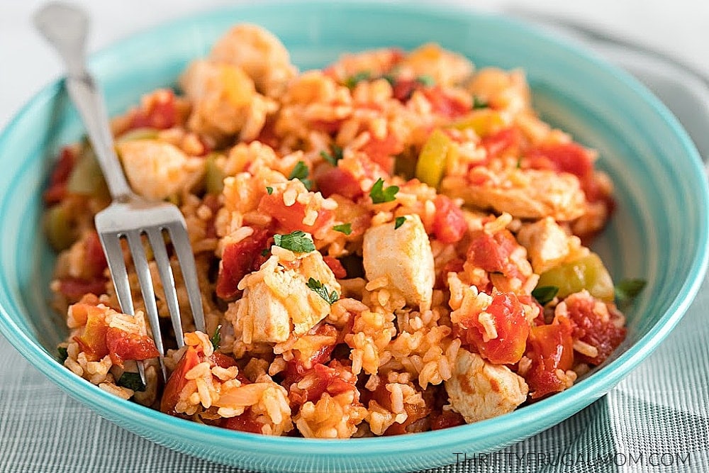 a bowlful of Spanish Chicken and Rice with a fork in it for a frugal menu plan