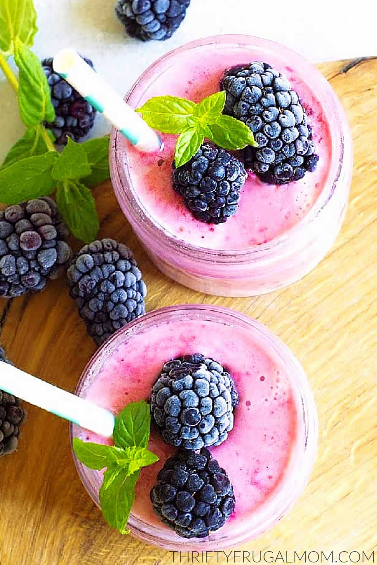 two cupfuls of frozen fruit smoothie with berries on top