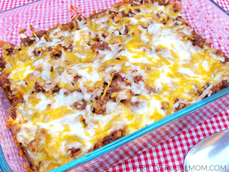 Cheap and easy Cheeseburger Casserole in a glass baking dish on a red gingham tablecloth