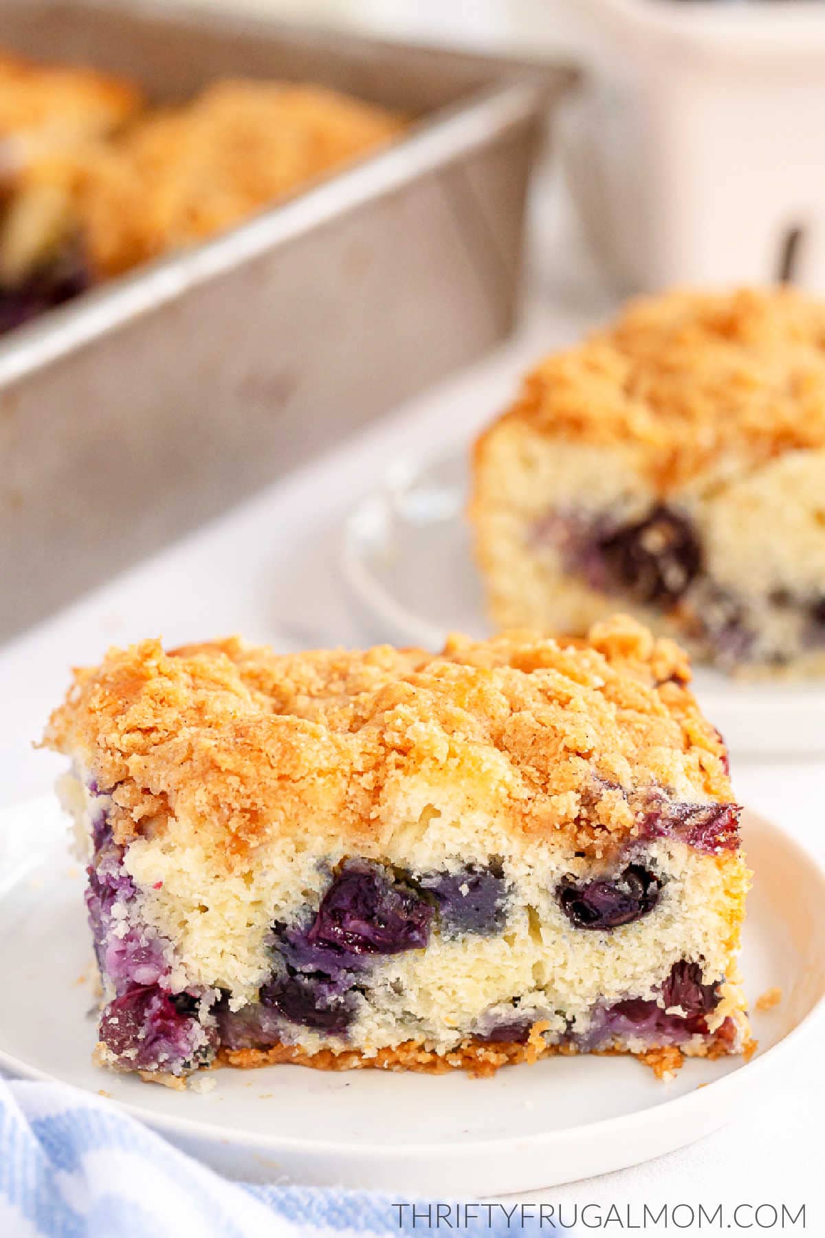 a piece of Blueberry Buckle Cake on a white plate 