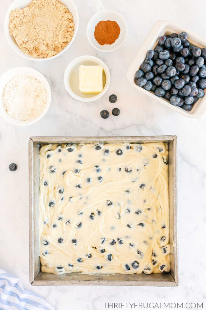 Blueberry Buckle cake batter in a metal cake pan