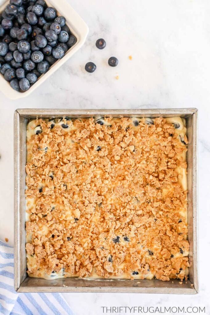 Blueberry Buckle coffee cake topped with streusel in a metal cake pan