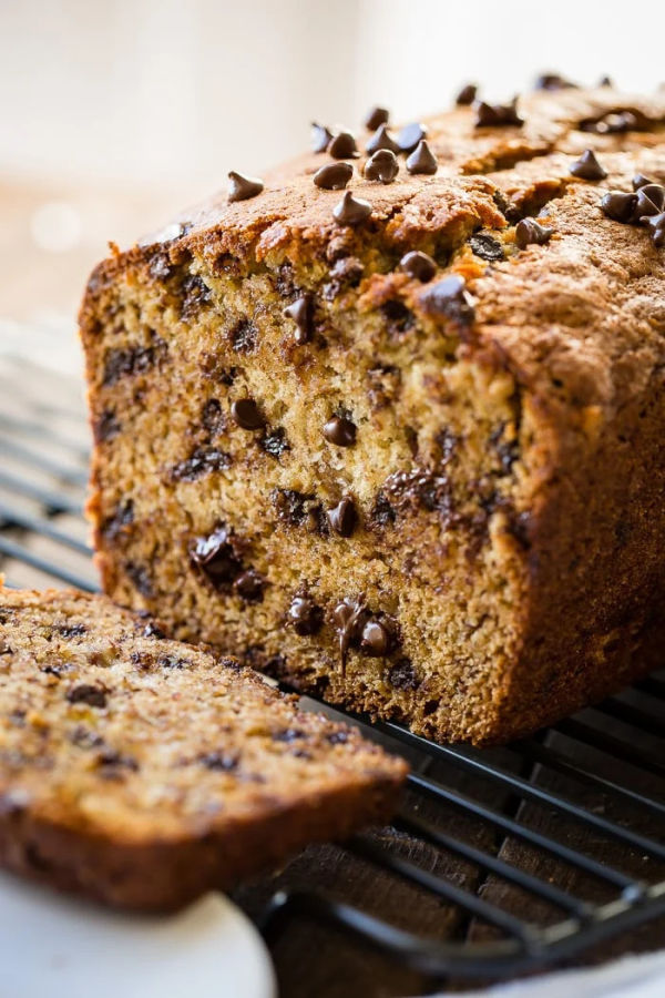 A close up of a loaf of butter free banana bread with chocolate chips