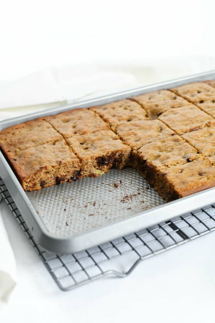 A big pan of Banana Chocolate Chip bars with several pieces taken out of it.