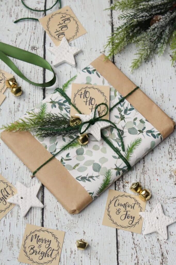 a wrapped Christmas gift with a Kraft paper gift tag and green ribbon