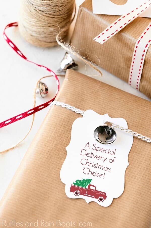 a red Christmas truck printable gift tag on a brown paper package