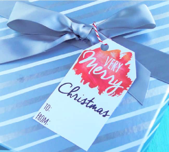 a very merry Christmas printable gift tag on a silver gift
