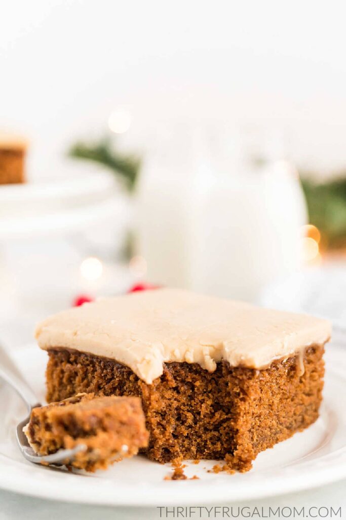 a gingerbread cake square topped with caramel icing on a small plate