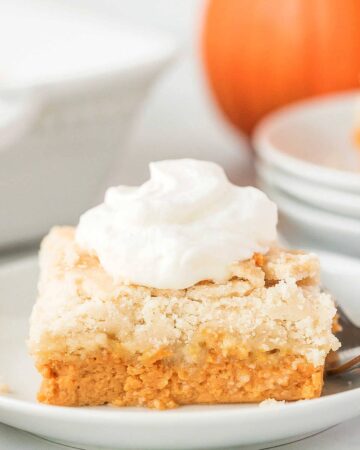 a slice of pumpkin dump cake with whipped cream on top