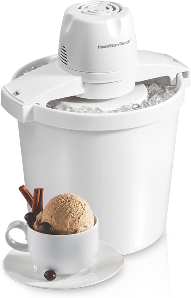 a white electric ice cream maker with a cupful of ice cream in front of it