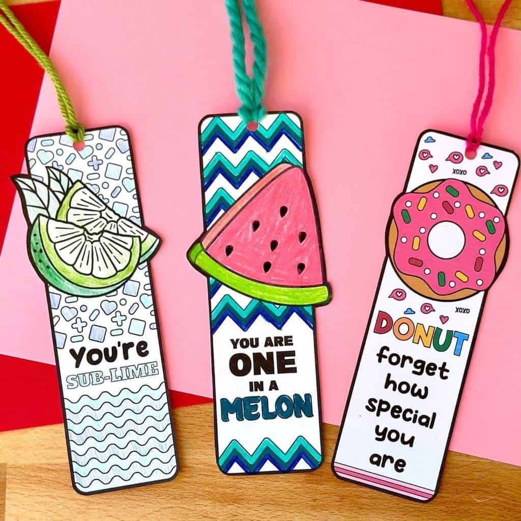 Three free printable homemade kid's Valentine bookmarks on a pink background.