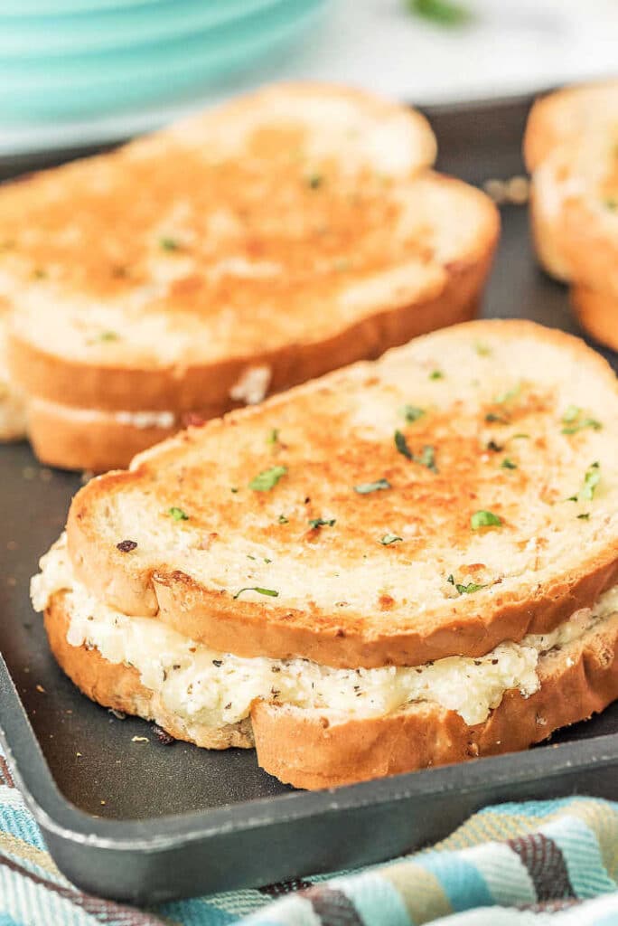 white pizza grilled cheese sandwiches on a baking pan