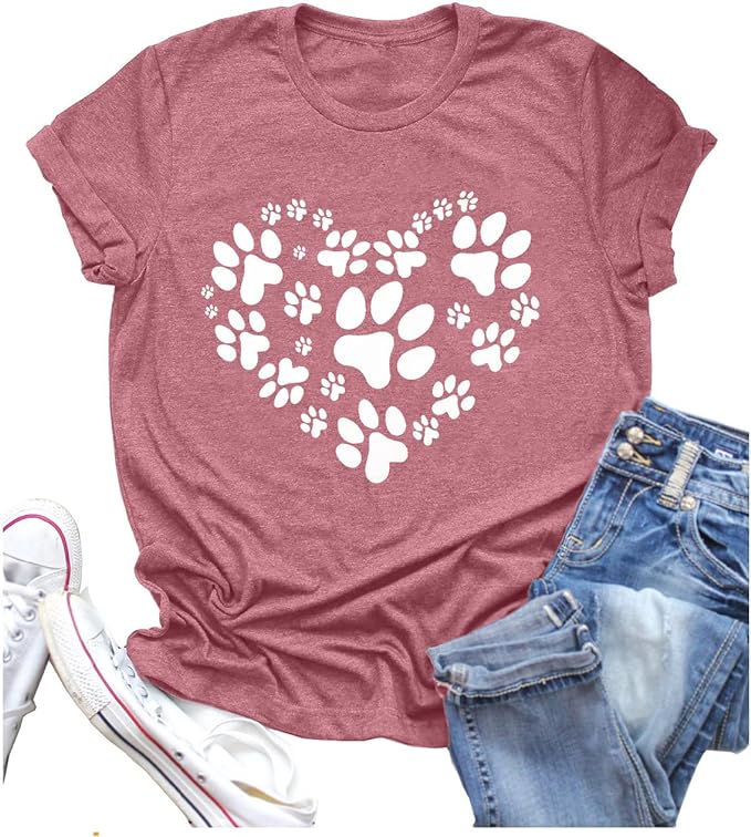 Pink shirt with white paw prints next to shoes and jeans- great gift for dog moms