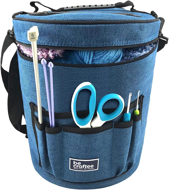 a blue round organizing bag holding various knitting tools